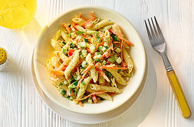 Houmous pasta salad with cucumber, tomatoes and carrots