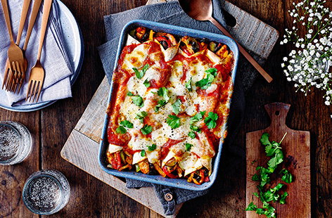 Load tortillas with paprika-spiced chicken, red pepper, beans and gooey mozzarella cheese to make this warming enchilada recipe. Bake until the cheese is golden and bubbling.