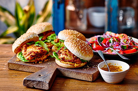 Fancy burgers for dinner? Make this easy chicken satay burgers recipe using just a jar of satay sauce for a one-step marinade, load up with lettuce and serve with a fresh tomato and red onion salad. 