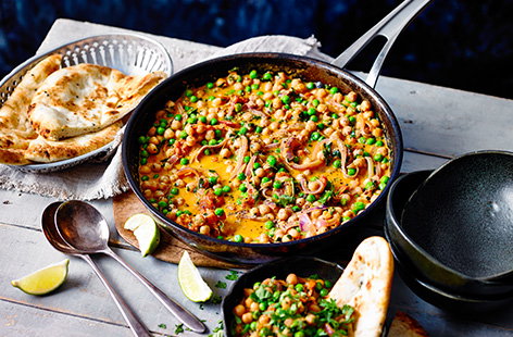 Make the most of the tins in your storecupboard with this chickpea coconut curry. Simmer chickpeas and peas in a fragrant coconut broth and serve with naan breads for dipping, for an easy vegan dinner recipe ready in 30 minutes.