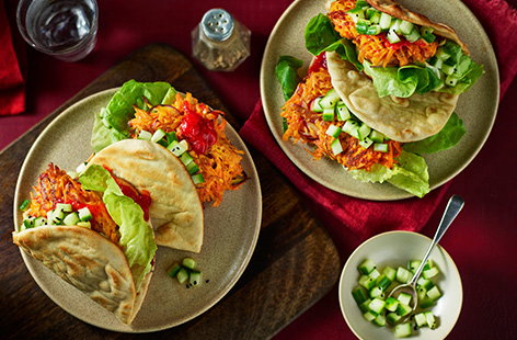 Add a bit of zing into your midweek meals with these carrot fritter burgers, serving two people. Spicy fritters are fried until golden and crispy. Stuff into flatbreads with fiery chilli relish and serve with a pickled cucumbers.