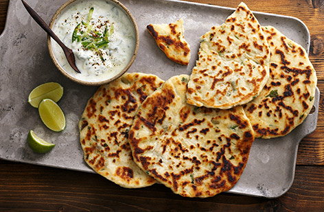 This yogurt and cucumber dip with homemade flatbreads, inspired by a classic Indian side dish, is the perfect accompaniment to a curry dinner