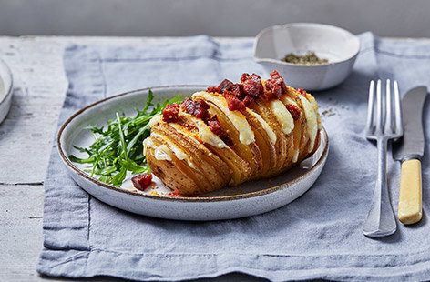 Move over jacket potatoes – this giant cheesy hasselback potatoes recipe takes this classic student dinner up a notch. Fill crispy hasselback potatoes with cheese and scatter with chorizo for easy, hearty comfort food.