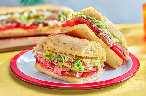 Use up leftover roast beef in this TikTok viral loaded grinder sub! Baguettes are coated in garlic butter and stuffed with tomatoes, beef and a mayonnaise-coated chopped salad