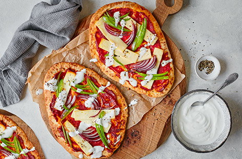 Treat the family to these Indian-inspired pizzas for a speedy Friday night dinner, ready in 20 minutes. Use naan breads as a cheat’s pizza base and top with onions, peppers, creamy paneer cheese and a drizzle of garlic yoghurt.