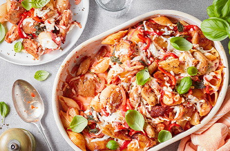 Spicy tomato sauce, antipasti peppers and chicken-style pieces come together in this easy pasta bake recipe topped with free-from mozzarella and fresh basil. The shell-shaped pasta catches the sauce perfectly. Dive in! 