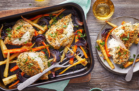 Save on washing up with this traybake recipe. Chicken breasts are stuffed with a creamy garlic and herb soft cheese filling and topped with a crunchy breadcrumb topping. They're roasted alongside root veg and topped with fresh parsley for an easy midweek meal.