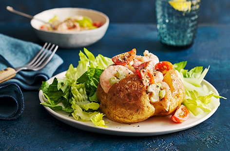 Spice up prawn cocktail with a few store cupboard staples and load into a fluffy jacket potato for a quick and delicious dinner for one.