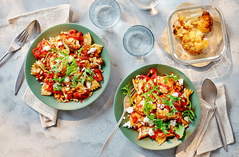 Use leftover harissa-spiced roasted cauliflower to make this super easy pasta recipe. Tossed in a simple homemade tomato sauce with feta, toasted pine nuts and rocket, it makes a great meat-free dinner or even a packed lunch for work.