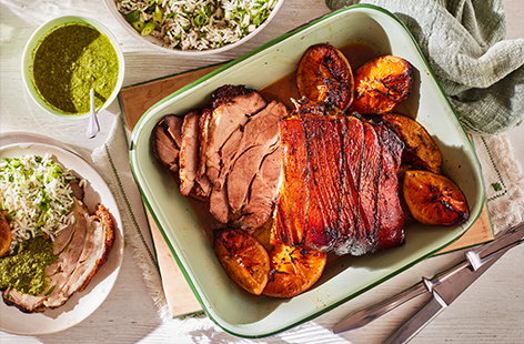 Bring some sunshine to your table with this Cuban-inspired pork recipe. With pork shoulder slow cooked to perfection with oranges and garlic and served with a herby green rice, it's a great alternative roast or celebration dinner recipe.