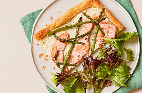 Garlic and herb soft cheese lines the base of this quick and simple salmon and asparagus tart