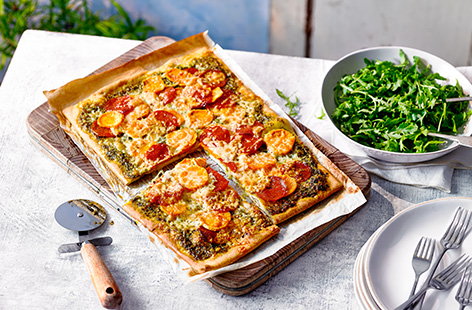 Serve up a feast with this family-style sweet potato, pesto and pepperoni pizza recipe. This unusual combination really works, using ready made pizza dough for a quick pizza fix - slice into generous squares and serve with a peppery rocket salad.