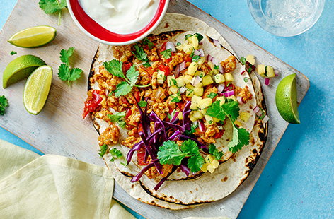 These chicken tacos are sunshine on a plate. Chicken mince and peppers are flavoured with coriander and lime, then topped onto tortillas with a tangy pineapple salsa