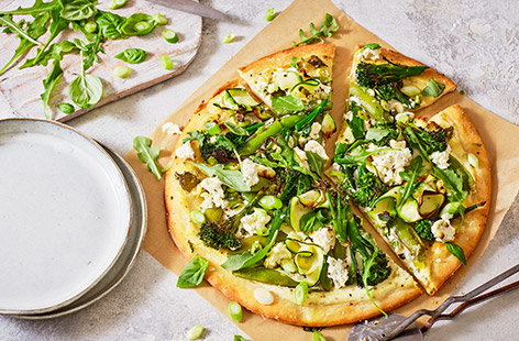 Next time you are craving pizza, make these cheesy green goddess pizzas. Creamy garlic and herb cheese makes a super simple pizza sauce, topped with plenty of fresh green veg and a scattering of extra cheese to finish.