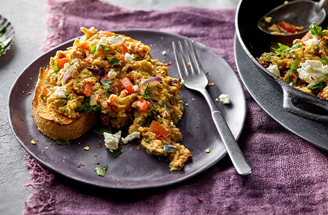 Treat mum to these spiced scrambled eggs for Mother's Day. They have red pepper, onion and tomatoes folded through them and are topped with crumbled feta and fresh parsley - delicious!