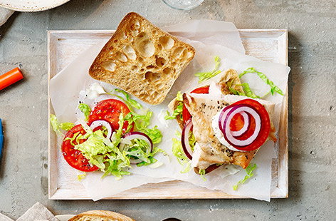 Ciabatta rolls are filled with healthy grilled chicken breasts, lettuce, tomato, onion and a little mayo.