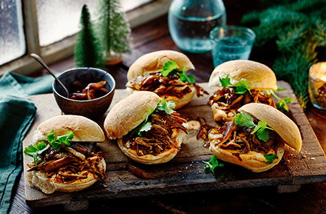 Inspired by festive street food, these allspice and star anise pulled pork sliders are perfect for feeding a crowd. In this recipe, festive spiced pork is served in a soft bun with sticky balsamic onions, harissa yoghurt and garnished with fresh lime and coriander.