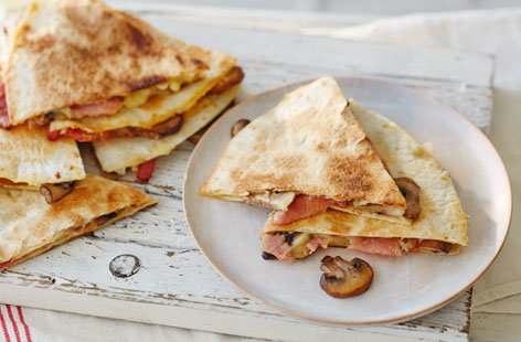 This gorgeously gooey quesadilla is oozing with melted cheddar, smoked bacon and juicy mushrooms - what more could you want from a breakfast treat?