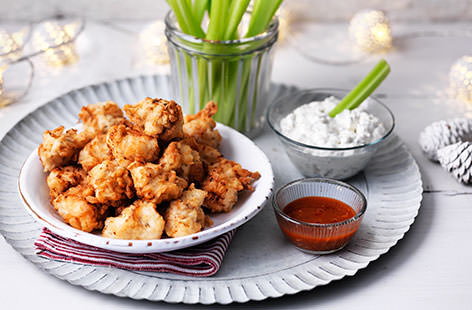 The perfect party food – buttermilk-marinated chicken lightly fried and served with a creamy blue cheese dip, fiery cayenne pepper sauce and crisp celery sticks. This easy recipe shows just how simple it is to make popcorn chicken at home