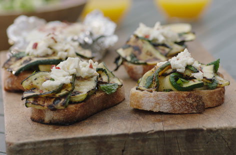 To make this super speedy vegetarian BBQ recipe, simply top toasted sourdough bread with delicately grilled slices of courgette and creamy baked feta