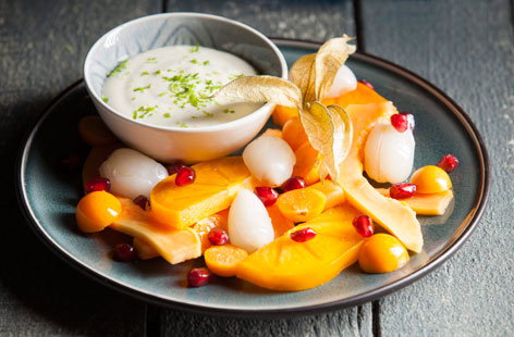 Papayas, persimmons, pomegranate, physalis and lychees are the exotic fruits that make up this vibrant fruit salad. Paired with a zesty lime cream, it's a dish that'll transport you to the tropics with every bite.