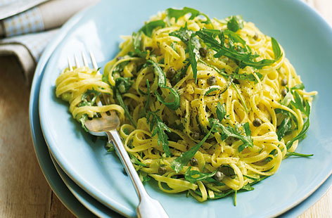 This lemony courgette linguine makes a zingy vegetarian dinner for two. Al dente pasta is stirred into lightly sautéed garlic, capers, and grated courgette. Crème fraîche, fragrant basil and peppery rocket are added to finish.