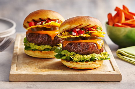 Try our Mexican-inspired burger recipe made with cool guacamole, crunchy tortilla chips and a fresh homemade pico de gallo on top of Tesco Finest ultimate brisket & chuck burgers. 