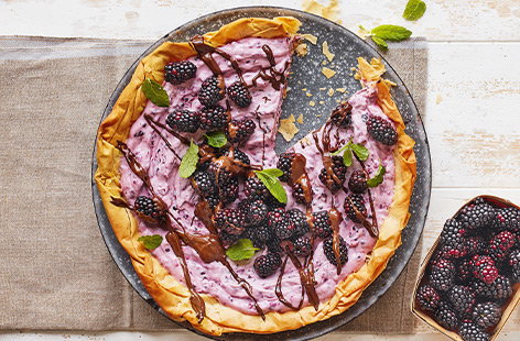 A pretty autumn tart, topped with deliciously sharp blackberries, fresh mint and a drizzle of dark chocolate