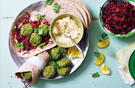 Make sure your lunch is full of colour with this vibrant falafel recipe that tastes as good as it looks. These healthy wraps are filled with creamy houmous, gorgeous green pea and coriander falafels and a crunchy beetroot slaw, for an easy veggie lunch.