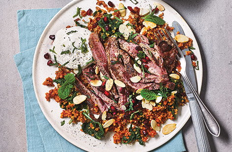 This hearty pilaf recipe swaps rice for bulgur wheat, and simmers slowly in a tangy tomato, garlic and onion stock, giving a wonderfully fluffy base for succulent seared lamb steak