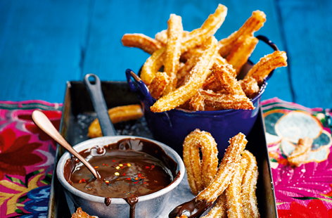 The ultimate way to round off a Mexican-themed sharing feast, these delicious churros are fried until golden and crisp, before being coated in sugar and served alongside a velvety dipping sauce of fiery chilli-chocolate