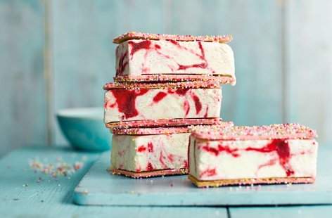 Surprise your guests with this refreshing sweet treat of homemade no-churn cherry ripple ice cream. Sandwiched between crisp wafers and finished off with white chocolate and a scattering of hundreds and thousands, it's sure to be a summer crowd-pleaser.