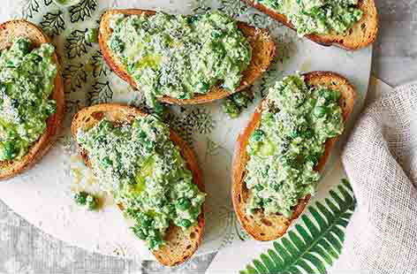 Impress friends with this easy starter, topping crisp grilled ciabatta with smashed peas, creamy cheese and fresh lemon. This is delicious served warm, but can also be made ahead and served at room temperature if you are short of time