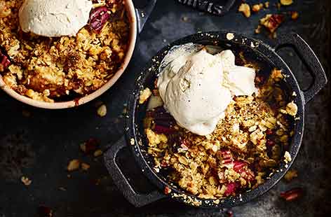 Let everyone dig into their own crumble with individual servings of this timeless, fruity pud. Lemon, oats and chopped nuts add plenty of extra flavour and crunch to balance the sweet layer of fruit underneath