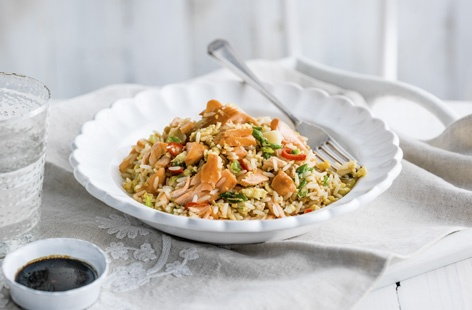 It's fast and easy to whip up this Chinese-style egg friend rice for a quick lunch or midweek meal. With flakes of salmon caramelised with honey and soy for a sweet taste, you can ramp-up the heat with slices of red chilli